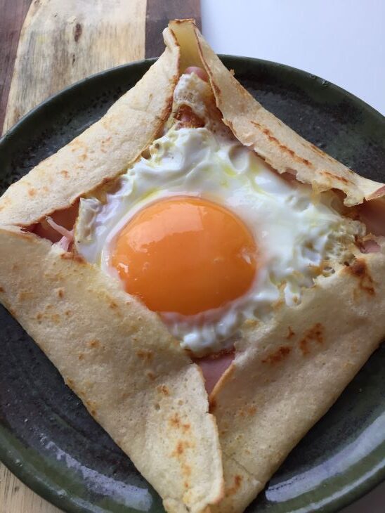 Ham and cheese savory crepes with an egg
